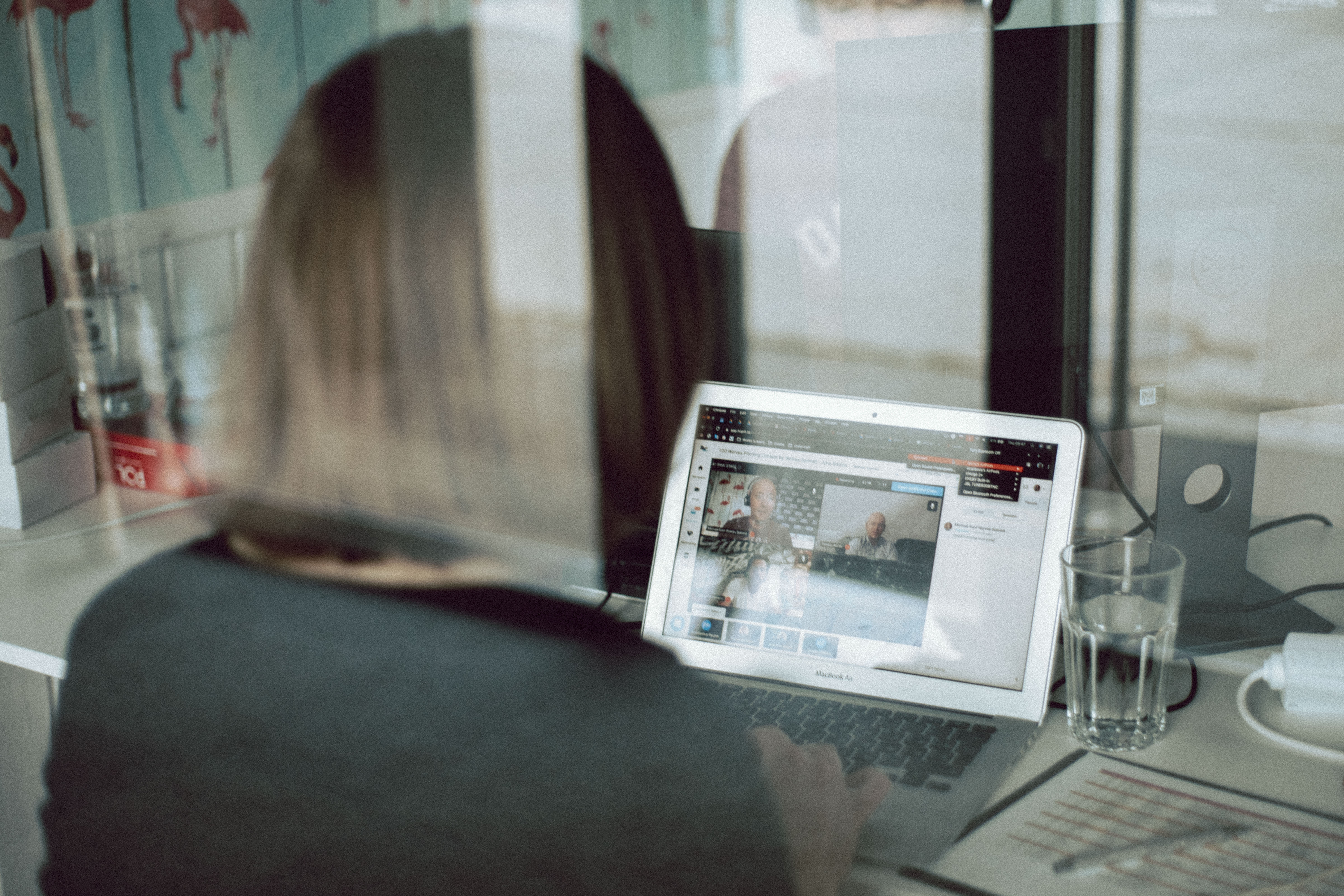 A women sitting in front of the computer during the video call.